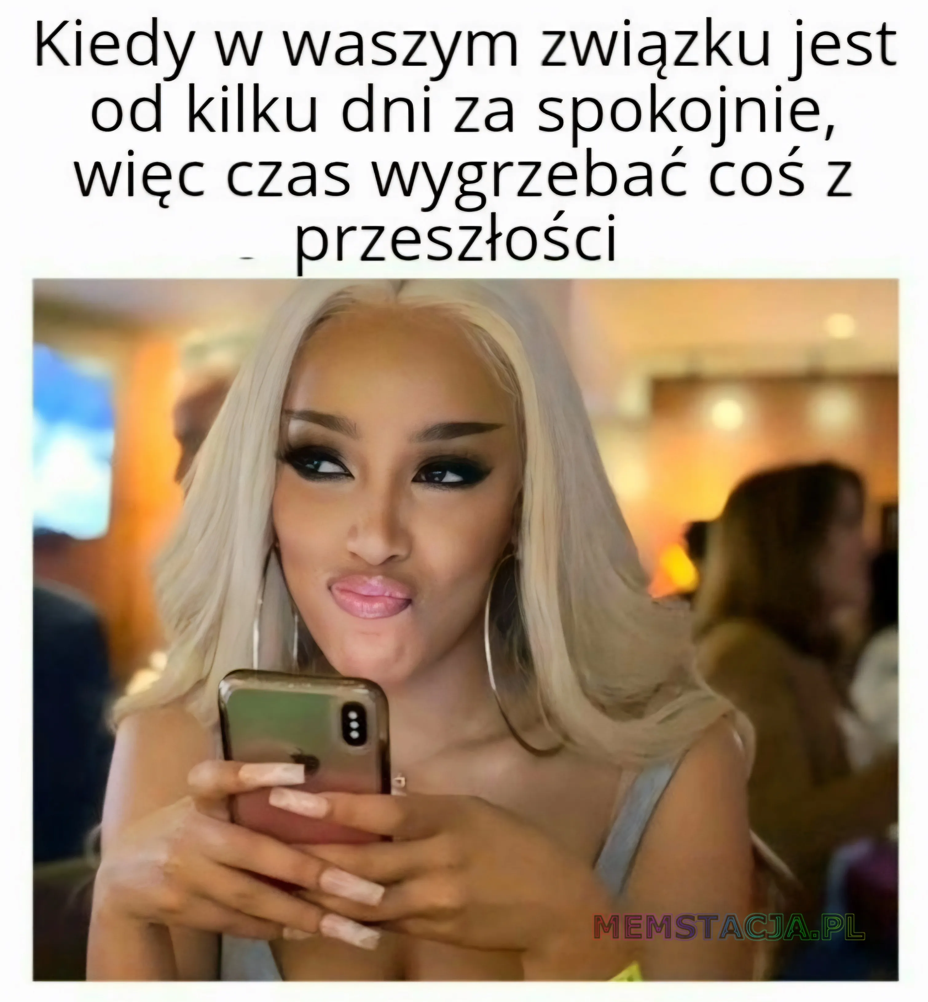 Kiedy w waszym związku jest od kilku dni za spokojnie, więc czas wygrzebać coś z przeszłości: Kobieta trzymająca telefon w rękach i podstępnie się uśmiechająca